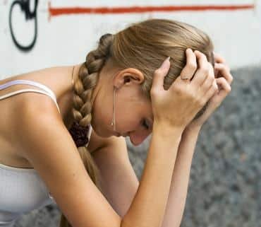 Young woman grieving the loss of a loved one from a suicide in Pinellas County.